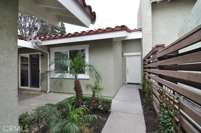 Welcome to paradise! Walk down the beautifully landscaped entryway taking notice of the dark mulch and eloquent palms.