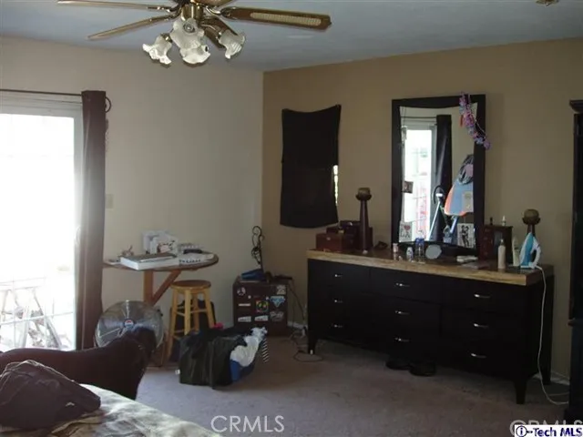 Master bedroom from a different angle showing the light from the sliding french doors.