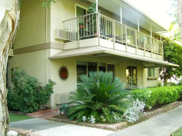 Exterior of building showing numerous windows facing creek