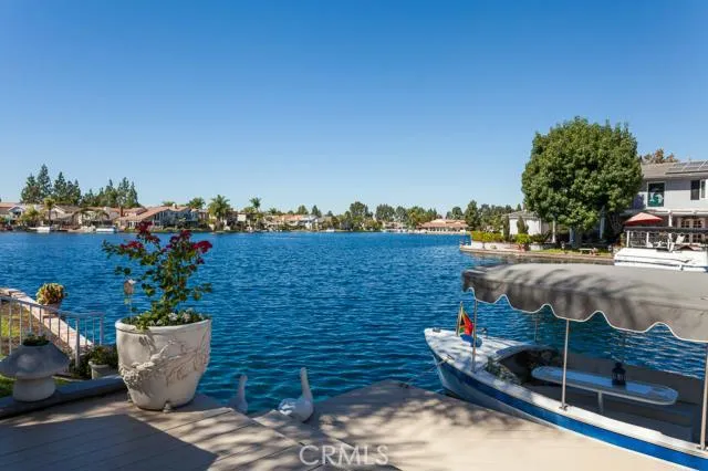 Lake Forest Keys ~ Resort Style Living! Enjoy Big Water Views and Incredible Sunsets from this Premium Lake Front Property