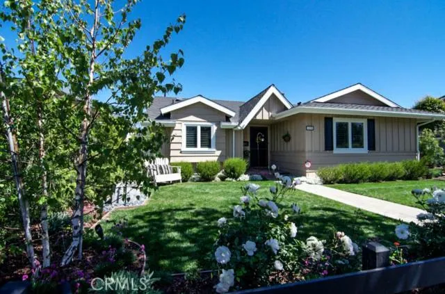 Lovely cottage details and beautiful landscape set the stage for this beautiful home.