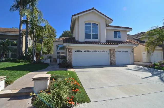 Custom stonework, tile roof, 3-car garage, and a paradise curb appeal will put a smile on your face every time you come home