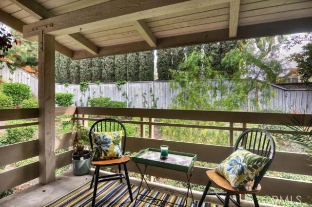 Back balcony with relaxing bistro table, plants and and out door rug.  The privacy will astound you!