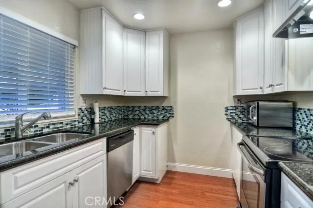 Kitchen with granite counter tops, subway tile backsplash, new solid wood cabinets and stainless steel appliances.