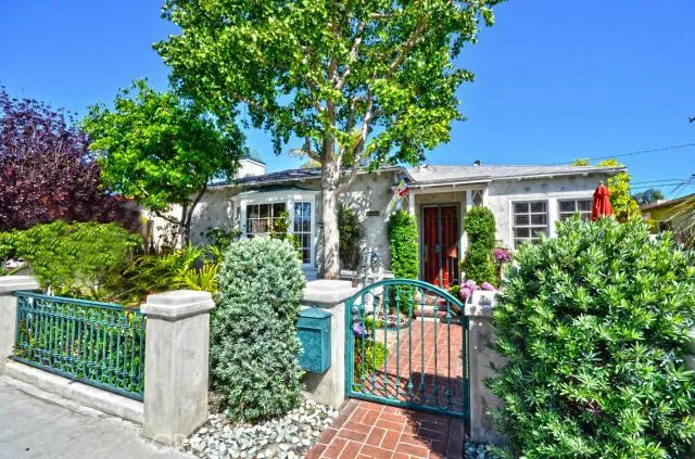 Front Exterior View with Iron fence and gate