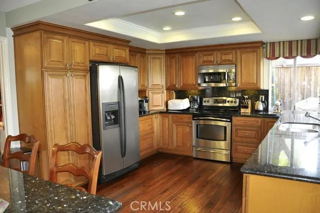 The heart of a home should beat to a cook's desires. Honey-colored maple cabinetry complete with newer stainless steel appliances. Yes, the even the refrigerator comes with the home. Breakfast? Lunch? Dinner? Step up or sit down at the breakfast bar.