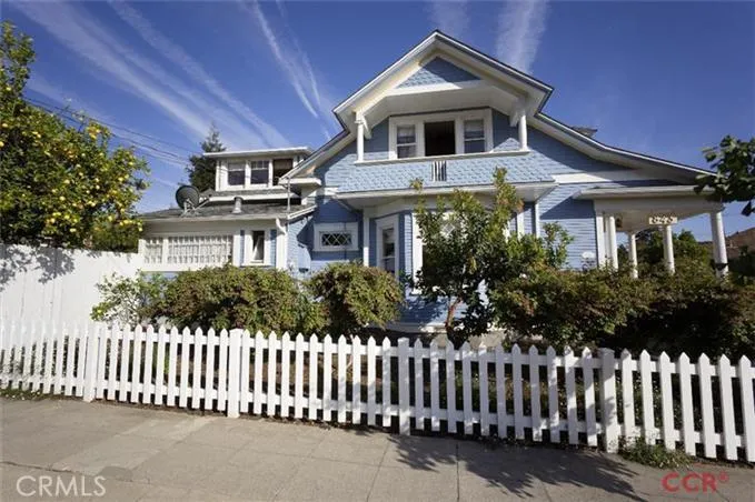 843 Upham: Front of home with Victorian charm, cottage garden, and white picket Fence. Balcony off large, upstairs bedroom offers views of San Luis Mountain.