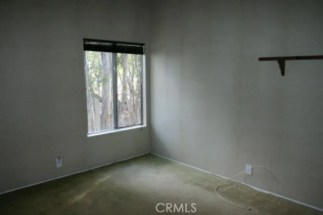 BR 2 - Large upstairs bedroom with vaulted ceiling and view of the trees