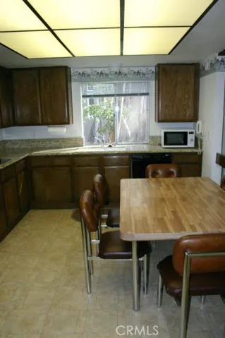 A long view of the kitchen. The window behind the sink looks out to the beautifully landscaped yard