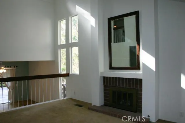 The living room has a gas or wood burning fireplace, vaulted ceilings and lots of windows for all day sunshine
