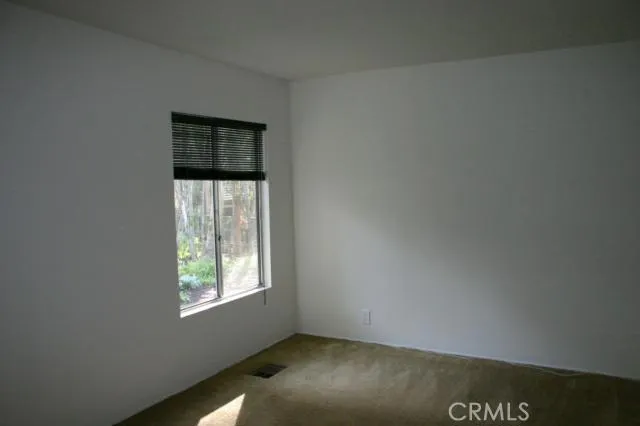 BR 5 - Downstairs bedroom off hallway that goes to inside laundry and access to garage. The window looks out to the landscaped side and back yards