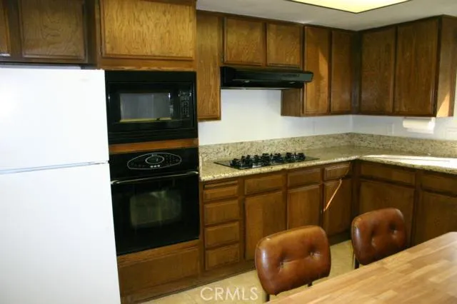 The kitchen has an eating area, lots of cabinets, a step in pantry and granite counters