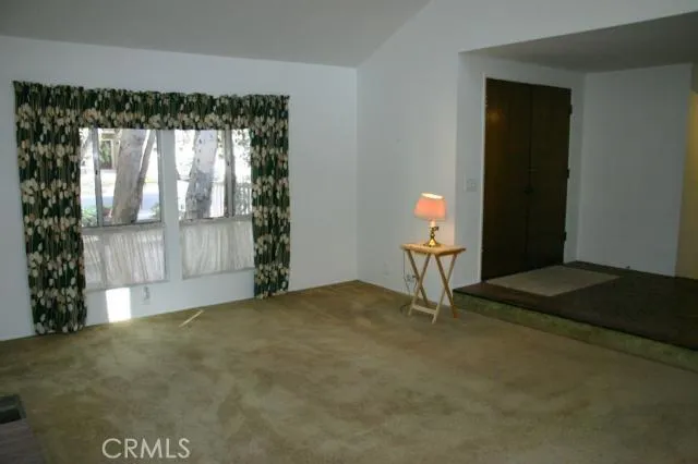 Looking across the living room to the double door entry