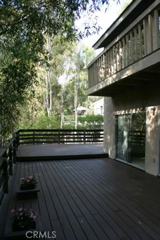 The deck wraps around the back of the house and has sliding glass doors from the family and dining rooms. Deck at the top is off the master bedroom