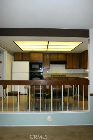 Standing in the family room looking up into the kitchen