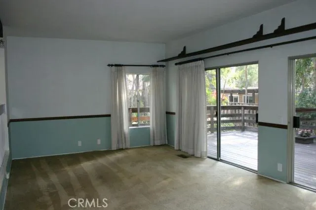 Looking in the opposite direction of the family room. Two sets of sliding doors open to the deck and bring in lots of sunlight