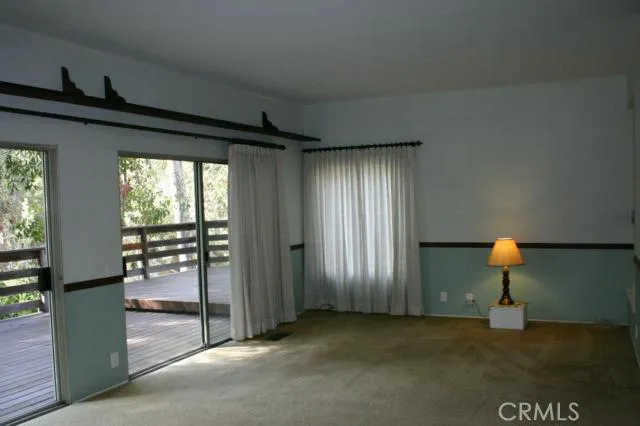 View from one end of the large family room. The wrap around deck goes across the entire back of the house