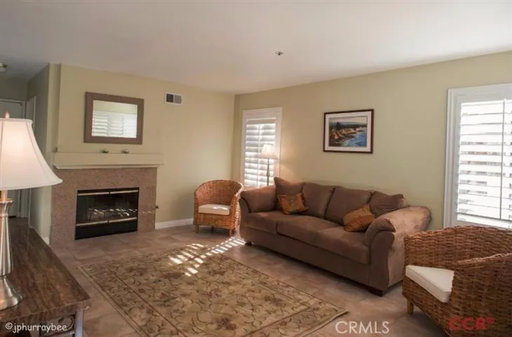 Large family room with fireplace with granite tiles that match the kitchen tiles