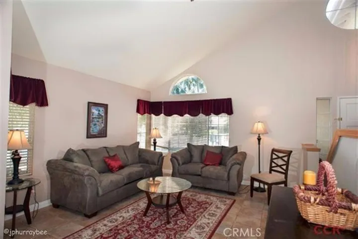 Lovely living room with vaulted ceilings. Light and Bright