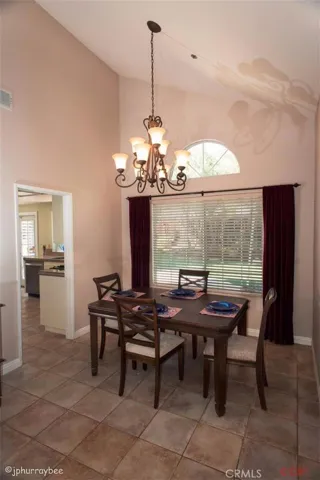 Dining room with beautiful chandelier. Tiled floor