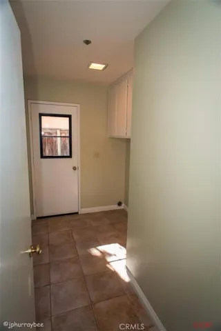 Large laundry room with loads of storage cabinets.