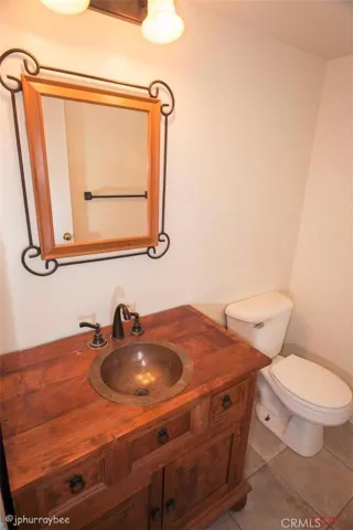 Guest bathroom with beautiful vanity and copper sink. Very classy