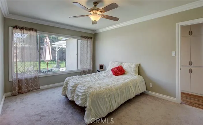 Master bedroom overlooking large backyard with walk-in closet.