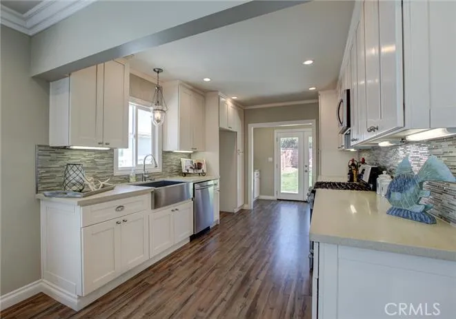 Laundry area off kitchen, french doors open up to large back yard perfect for family or entertaining.