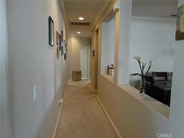 Hallway leading to the bedroom, laundry and access to the garage.