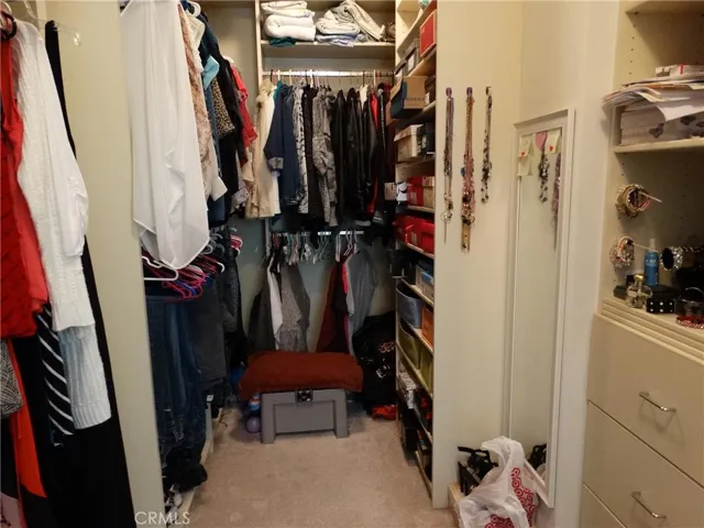 Spacious walk in closet in the master features built-in drawers and shelving for ease and organization.
