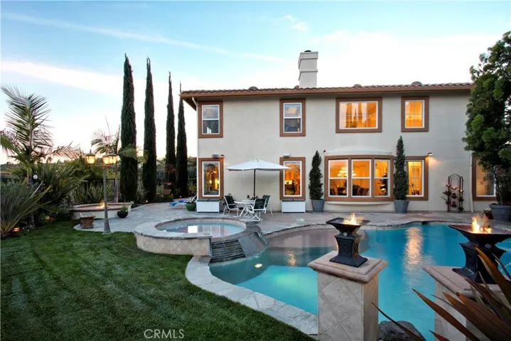 True Estate Grounds with lush lawn, and large patio spaces define this home! Entertain  and Live in Grand Style!