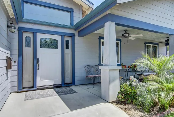 Inviting front porch and custom front door with sidelights say "welcome" beautifully!