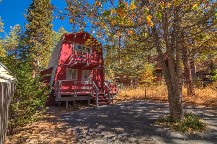 Level treed lot with just a few steps to front deck. Two car parking.