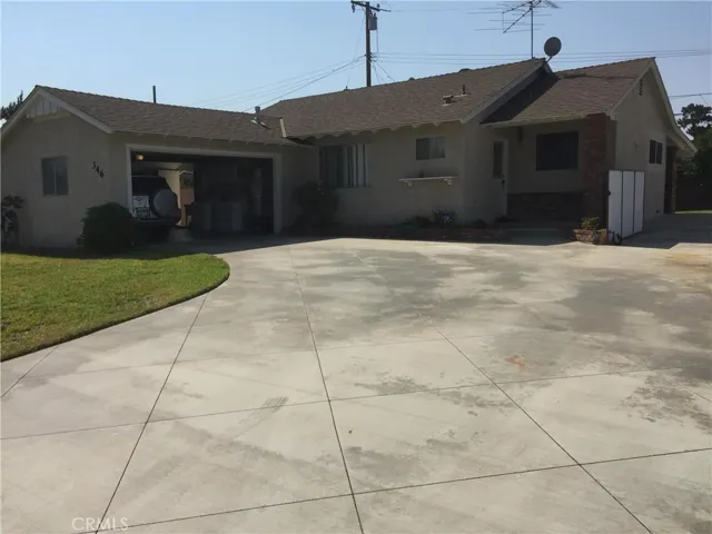Front view of the house, lot of space to park cars, play basketball or skateboard
