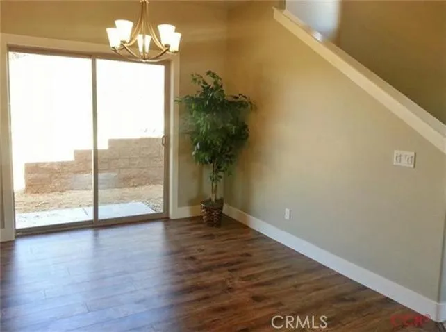 Dining room with slider to backyard; dining and kitchen area have engineered wood flooring, attractive and easy to maintain.