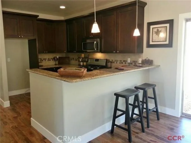 Kitchen with breakfast bar; granite tops