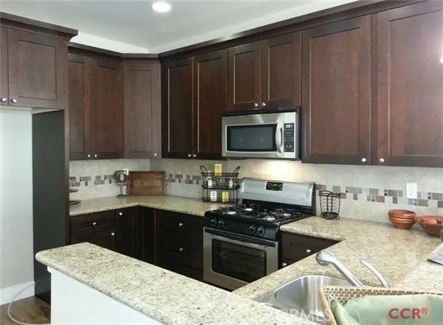 The Java Mocha cabinetry is complemented by a tile back splash and stainless appliances.