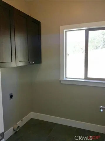 Laundry room is nicely tucked behind guest bath.