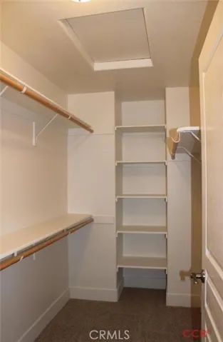 Generously sized walk in closet! All bedroom closets have wood shelf and pole system.