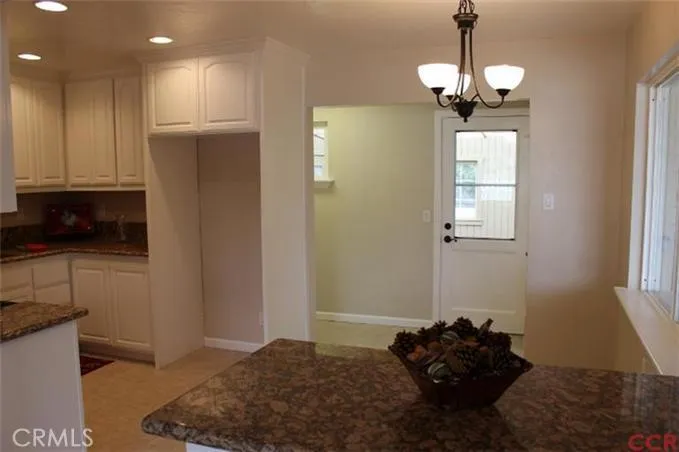 View of dining area to back door leading to sunroom.