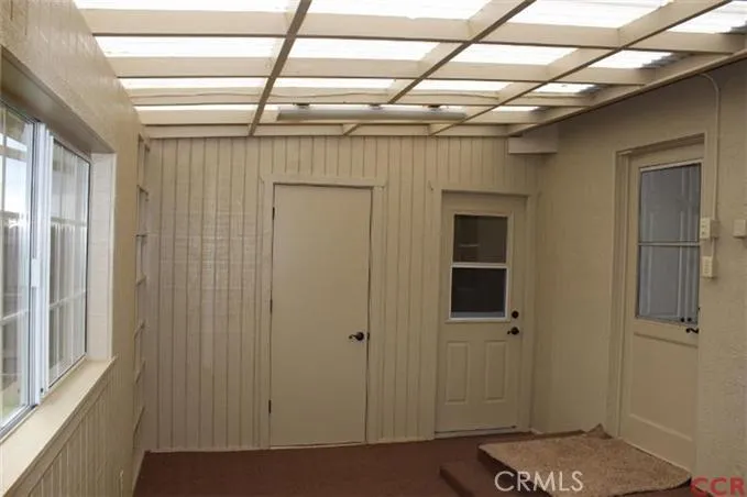 Sunroom located at back of kitchen area. Door to carport and extra storage room!