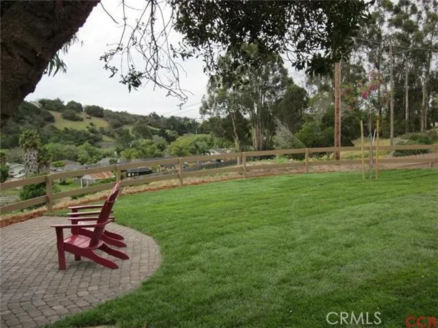 Lawn with additional paver patio in back area of home.