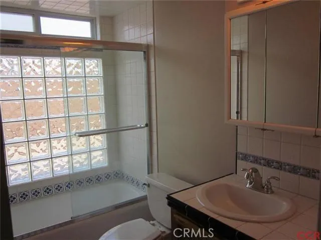 Hall bath with glass block wall.