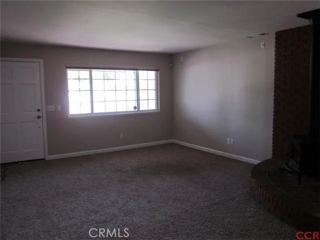 Entry and living room with wood stove