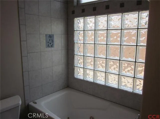 Master bath with jetted tub and glass block.