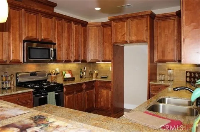 Tile backsplash and stainless appliances finish off this gorgeous kitchen.