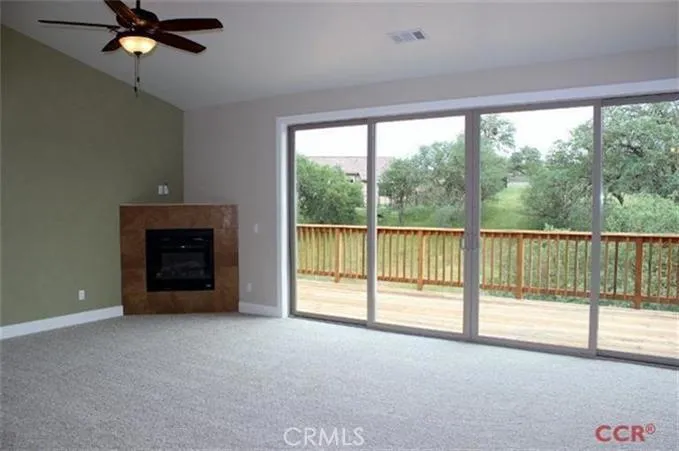Great room features a 14ft wide double sliding glass door to the deck! Along with corner fireplace and Venetian plaster accent wall