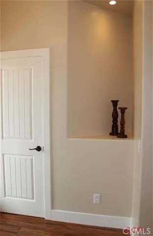 Entry way features lighted display nook and coat closet