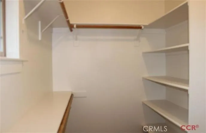 Large master closet with wood shelf & pole system