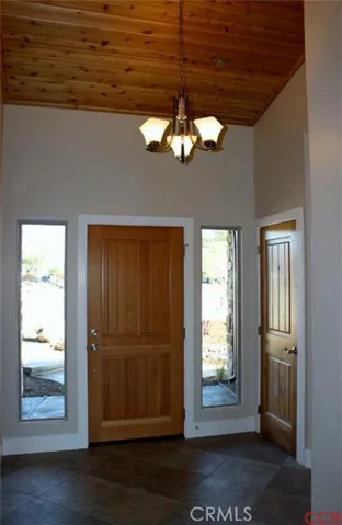Front entry with tiled floor, glazed doors and exposed wood ceiling